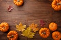 Autumn Thanksgiving background. Pumpkins and leaves on rustic table top view Royalty Free Stock Photo