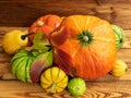 Autumn thanksgiving composition with assorted pumpkins on wooden table