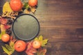 Autumn and Thanksgiving day table setting with fallen leaves, pumpkins, black platter and vintage cutlery on brown Royalty Free Stock Photo