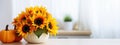 Autumn Thanksgiving decorative arrangement of sunflower flowers and chrysanthemums in pumpkin on white table at home. Thanksgiving