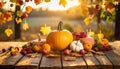 Autumn Thanksgiving pumpkins, fruits and falling leaves on rustic wooden table