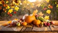 Autumn Thanksgiving pumpkins, fruits and falling leaves on rustic wooden table