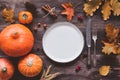 Autumn thanksgiving table setting with empty plate, cutlery and pumpkins Royalty Free Stock Photo
