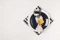 Autumn thansgiving and halloween tableware flat lay with plate and leaves on white cloth background