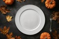 Autumn-Themed Table Setting with Pumpkins and Fall Leaves Royalty Free Stock Photo