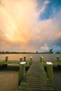 Beautiful landscape image of a sunlit shower with rainbow over a lake