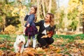 Autumn time, weekend and holidays. Family playing with dog in autumn leaves Royalty Free Stock Photo