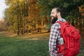 Autumn tourism happy guy hiking nature park