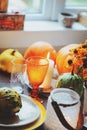Autumn traditional table setting for Thanksgiving or Halloween, with candles, flowers and pumpkins. Royalty Free Stock Photo