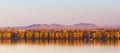 Autumn Trees Mirroring On Danube river with Macin Mountains in background