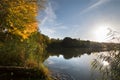 Autumn trees, sky and clouds reflected in water surface. Royalty Free Stock Photo