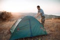 Tourist sets up a tent