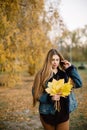 Autumn trend. Beautiful woman fashion model with long hair having fun in fall park outdoors. Pretty tenderness model Royalty Free Stock Photo