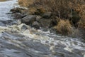 Autumn turbulent river flow and boulders