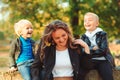 Autumn vacation. Happy family enjoying autumn. Mother with children walking in autumn park Royalty Free Stock Photo