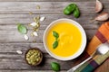 Autumn vegetable or pumpkin soup in white bowl on wooden table top view. Royalty Free Stock Photo