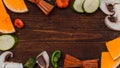 Autumn vegetables with autumn leaves on wooden background with f