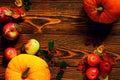 Autumn vegetables, pumpkins with red apples and walnuts on a brushed wooden background Royalty Free Stock Photo