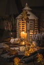 Autumn veranda or patio in night with white pumpkins, lights and dried leaves Royalty Free Stock Photo