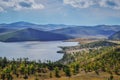 Autumn view of bay of Lake Baikal with islands and peninsulas and mountains on horizon. Sunny landscape. Blue water