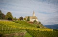 Autumn view of the Church of the idyllic village of Cortaccia. Cortaccia extends on the sunny side of the wine road. South Tyrol,