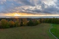 autumn view from the observation tower of birch trees, mown grass and sunset, path on the right