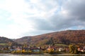 Autumn view of small austrian village on a river bank Royalty Free Stock Photo
