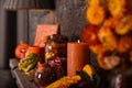 An autumn vintage decorative composition with a candle, pumpkin and dried flowers.