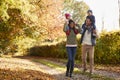 Autumn Walk With Parents Carrying Children On Shoulders Royalty Free Stock Photo