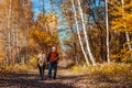 Autumn walk. Senior couple walking in fall park. Happy man and woman talking and relaxing outdoors Royalty Free Stock Photo