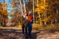 Autumn walk. Senior couple walking in fall park. Happy man and woman talking and relaxing outdoors Royalty Free Stock Photo