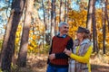 Autumn walk. Senior couple walking in fall park. Happy man and woman talking and relaxing outdoors Royalty Free Stock Photo