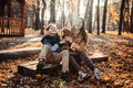 Autumn walks with dog. Happy family mother and teen boy son having fun with cute cocker spaniel puppy in autumn park Royalty Free Stock Photo