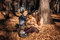 Autumn walks with dog. Happy family mother and teen boy son having fun with cute cocker spaniel puppy in autumn park Royalty Free Stock Photo