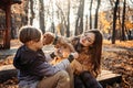 Autumn walks with dog. Happy family mother and teen boy son having fun with cute cocker spaniel puppy in autumn park Royalty Free Stock Photo