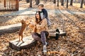 Autumn walks with the family. Happy family mother and teen boy son having fun with cocker spaniel puppy in autumn park Royalty Free Stock Photo