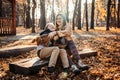 Autumn walks with the family. Happy family mother and teen boy son having fun with cocker spaniel puppy in autumn park Royalty Free Stock Photo