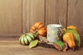 Autumn wallpaper with candle, pumpkin decorations and fall leaves. Thanksgiving table