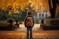 Autumn wanderlust Little boy with backpack strolls through park Royalty Free Stock Photo