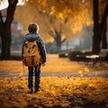 Autumn wanderlust Little boy with backpack strolls through park Royalty Free Stock Photo