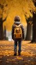 Autumn wanderlust Little boy with backpack strolls through park Royalty Free Stock Photo