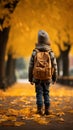 Autumn wanderlust Little boy with backpack strolls through park Royalty Free Stock Photo