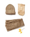 Autumn warm clothes, knitted hat, wool scarf and suede gloves with craft paper for copy space. Warm wear Royalty Free Stock Photo