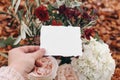 Autumn wedding, birthday mockup scene, composition with olive branches and pink rose flowers. Closeup of woman`s hands