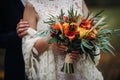 Autumn wedding bouquet in the hands of the bride .Walk in nature Royalty Free Stock Photo