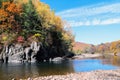 Autumn wild forest, rocks and river. Vivid landscape, colorful scene with water