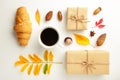 Autumn or winter composition. Cup of coffee, gift, dried autumn leaves, croissant on white background. Flat lay, top view, copy Royalty Free Stock Photo