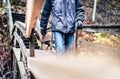 Autumn, winter, or fall walk in forest. Man on a wooden trail, path or bridge. Happy hiker with jacket and jeans enjoying outdoor. Royalty Free Stock Photo