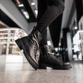 Autumn-winter fashion collection of women`s warm boots. Stylish young woman in trendy seasonal leather shoes with shiny Royalty Free Stock Photo