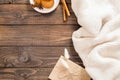 Autumn or winter flatlay composition with white wool plaid, crft paper envelope, cinnamon sticks, cookies, dry flowers. Cozy home Royalty Free Stock Photo